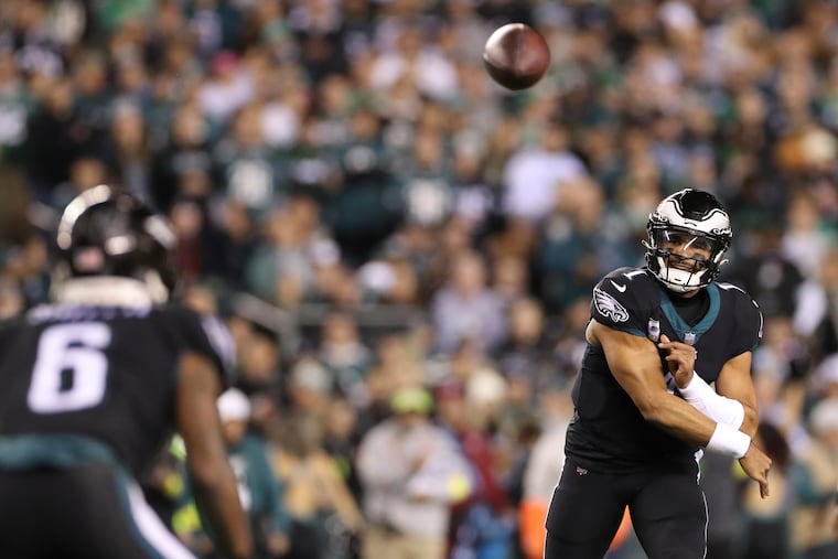 Eagles quarterback Jalen Hurts throws the football to teammate wide receiver DeVonta Smith during the first quarter against the Green Bay Packers on Sunday, November 27, 2022 in Philadelphia.