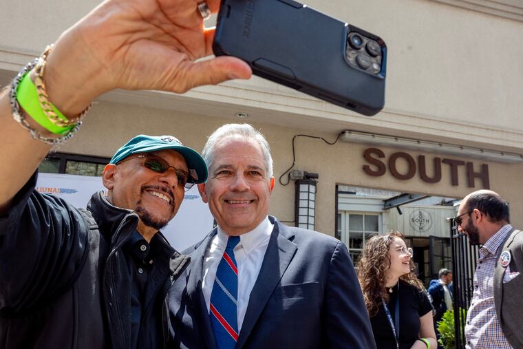 District Attorney Larry Krasner (right) poses for a selfie with State Sen. Vincent Hughes outside South Restaurant & Jazz Club Tuesday, May 20, 2025, at the primary election day lunch and political gathering.