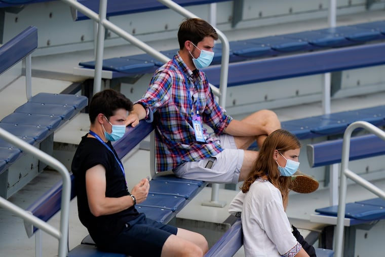 Spectators wearing protective masks practiced social distancing while they watched from the stands during the Western & Southern Open tennis tournament at Flushing Meadows in New York on Aug. 22.
