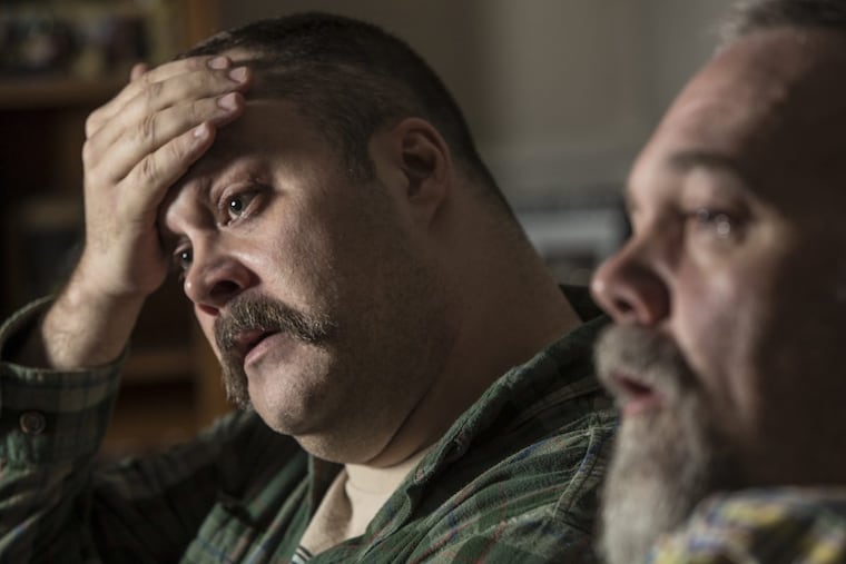 Zach Ruff, left, the Downingtown assistant principal who was fired after his confrontation with teen abortion protesters outside his school last spring, talks about the day that it happened and the school districtÕs response, as he sits along side his husband, Ron Logan, right, in Downingtown, PA, on Tuesday December 5, 2017.