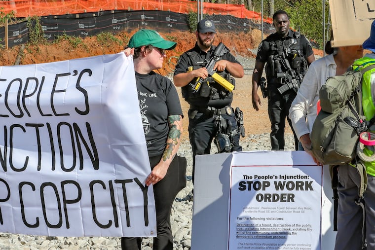 Protesters gathered on Constitution Road at the site of Atlanta's proposed public safety training center Thursday in DeKalb County, Ga., after several protesters chained themselves to construction equipment in an effort to halt work.