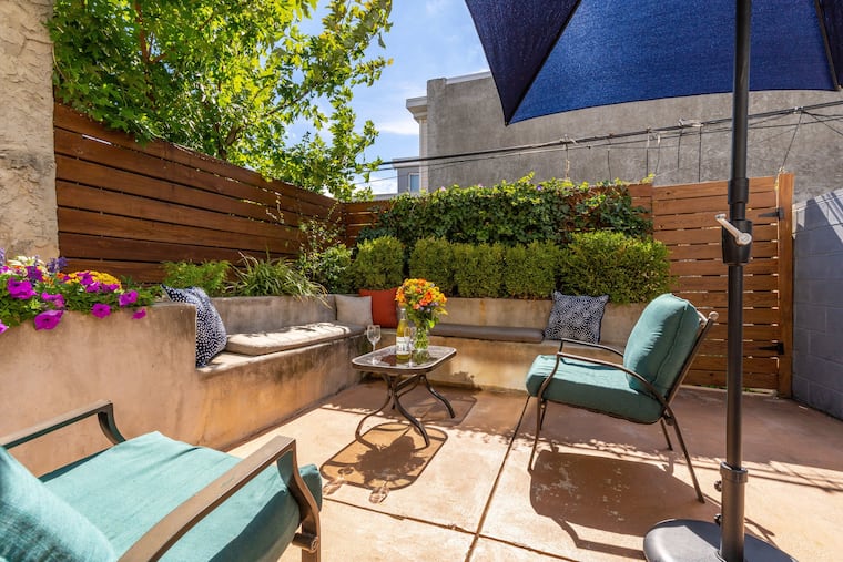 The living room opens to a private backyard patio.