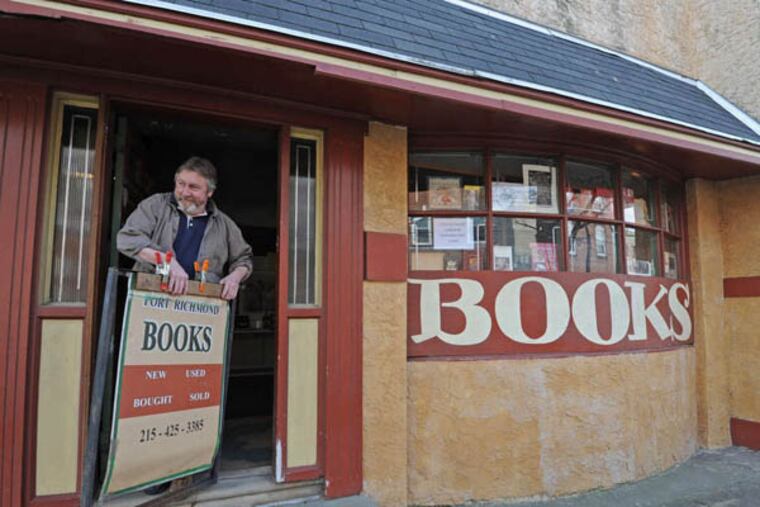Port Richmond Books, a used bookstore owned and operated by Greg Gillespie on Jan. 9, 2013. Here, Gillespie carries out the sign for the store as he opens for the day. APRIL SAUL / Staff Photographer