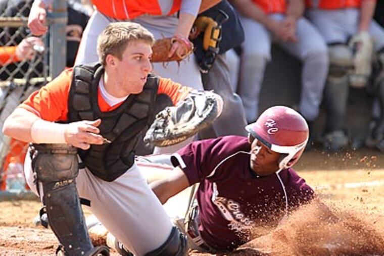 Cherokee catcher Craig Joseph takes a late throw as Holy Cross' John Walls slides into home safely. (Charles Fox/Staff Photographer)