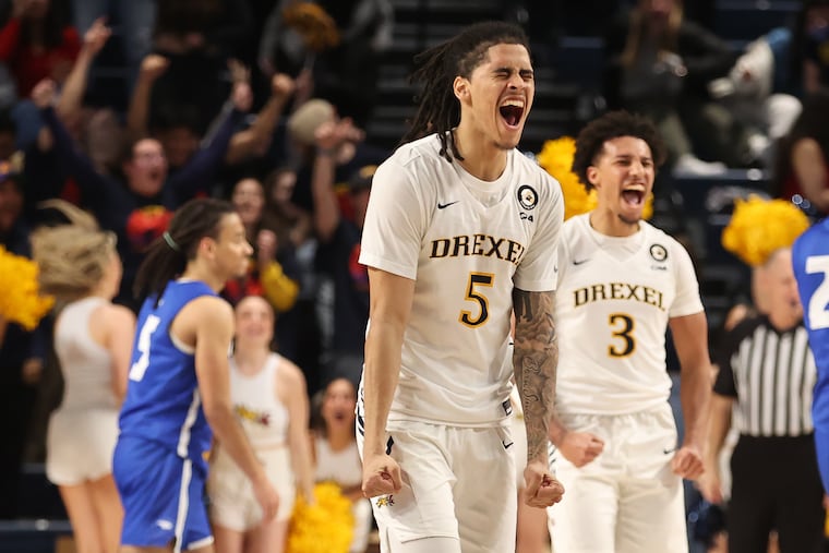 Kobe MaGee (left) and Jamie Bergens of Drexel celebrate the Dragons' 79-77 victory over Hofstra on Thurday.