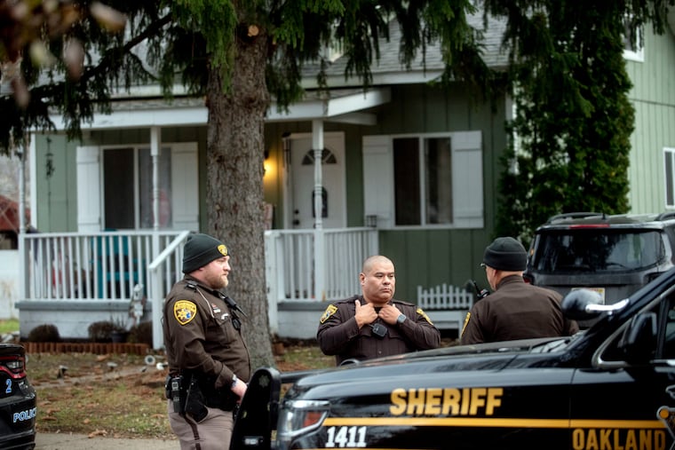 Three Oakland County Sheriff's Deputies survey the grounds outside of the Crumbley residence while seeking James and Jennifer Crumbley, parents of the alleged Oxford High School shooter, on Friday, Dec. 3, 2021 in Oxford. (Jake May | MLive.com) Jake May