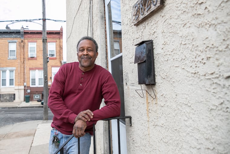 Dwayne Fair outside his North Philadelphia home. Fair, a former Philadelphia Housing Authority renter, used a PHA program that helps people save money to buy his childhood home.