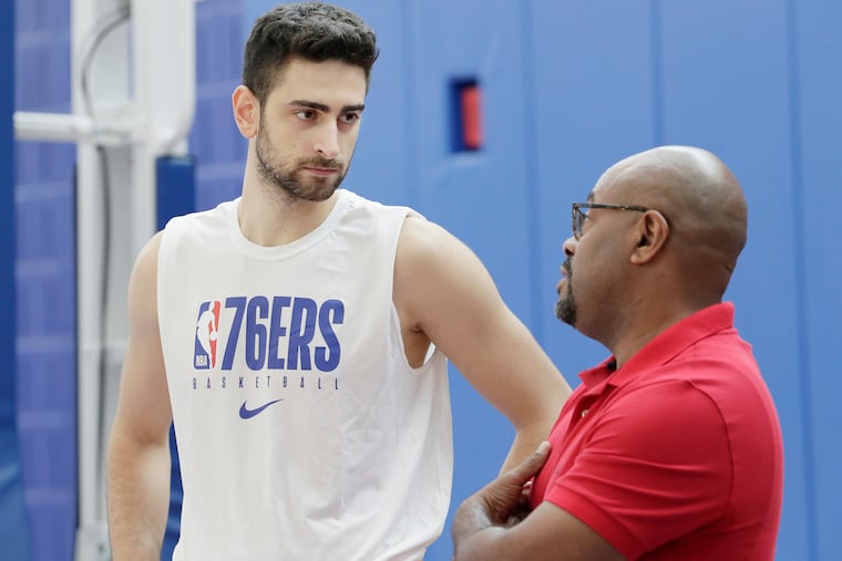 76ers beat writer Keith Pompey (right) talks with Furkan Korkmaz at practice. Pompey returned home Thursday after being in self-quarantine.