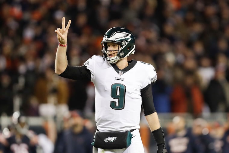 Eagles quarterback Nick Foles raises his fingers for a two-point conversion attempt against the Chicago Bears.