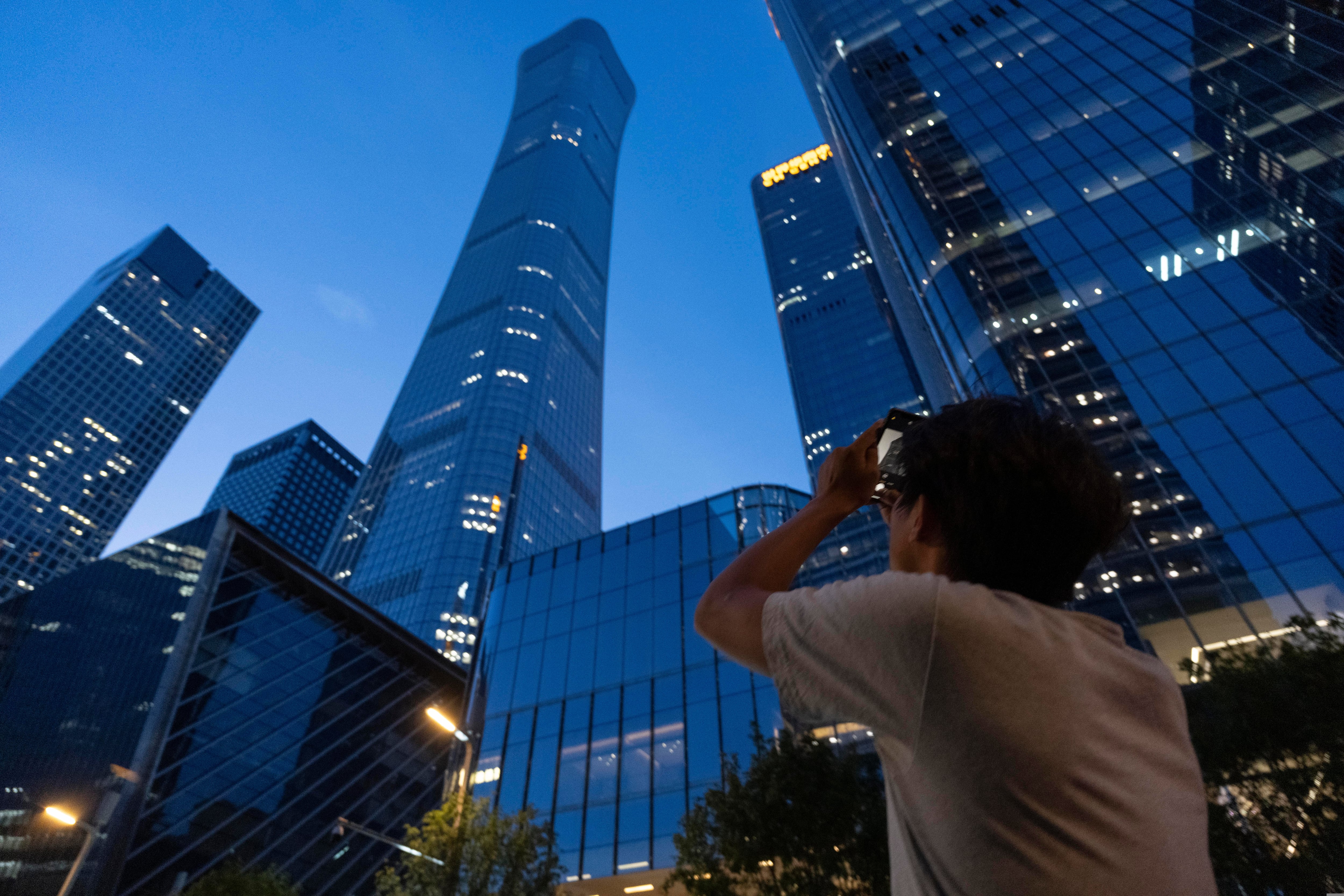 Small plane crash at Beijing high-rise kills the pilot and injures 13, authorities say