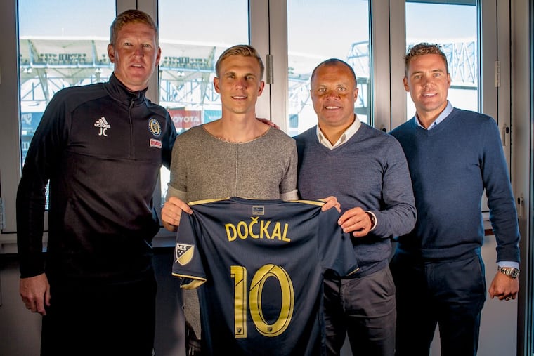 New Philadelphia Union midfielder Borek Dockal (center left) poses with his new jersey and (from left to right) manager Jim Curtin, sporting director Earnie Stewart and technical director Chris Albright.