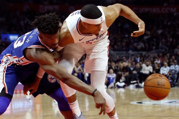 Jimmy Butler (left) battles the Clippers' Tobias Harris during the Sixers' win in Los Angeles on Tuesday.
