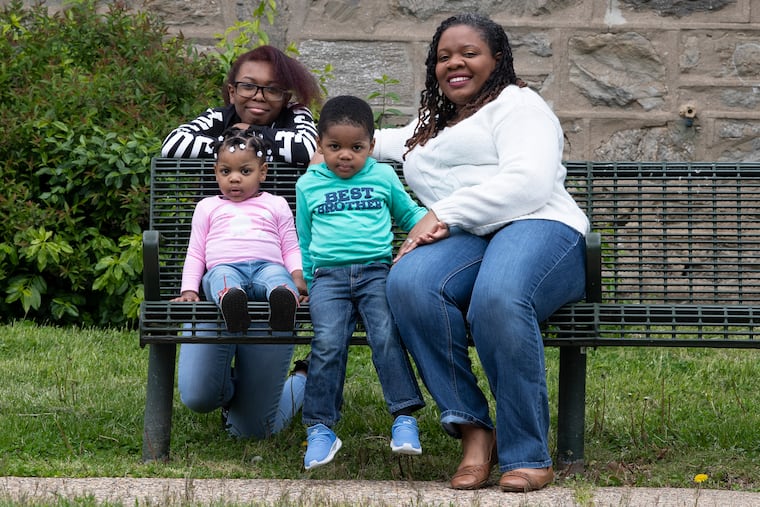 Kyana Hopkins-Thomas, right, is photographed with her kids, Imani Thomas, 15; Imara Thomas, 1; and Keion Thomas, 2, near their home in Philadelphia. Kyana is teacher who is juggling her students' needs with her own children.