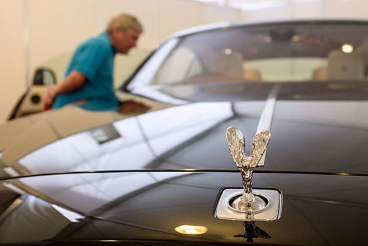 The "The Spirit of Ecstasy" or "Flying Lady" mascot sits on the hood of a Wraith automobile, manufactured by Rolls-Royce Motor Cars Ltd., on display at the company's stand at the Singapore Yacht Show in Singapore, on Thursday, April 10, 2014. The show runs through April 13. (Charles Pertwee/Bloomberg)