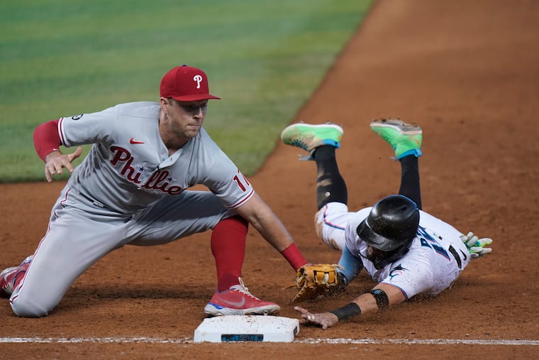 Phillies first baseman Rhys Hoskins tags the Marlins' Miguel Rojas on a pickoff throw by catcher Rafael Marchan in the eighth inning Thursday in Miami. The Phillies won the game, 3-2.