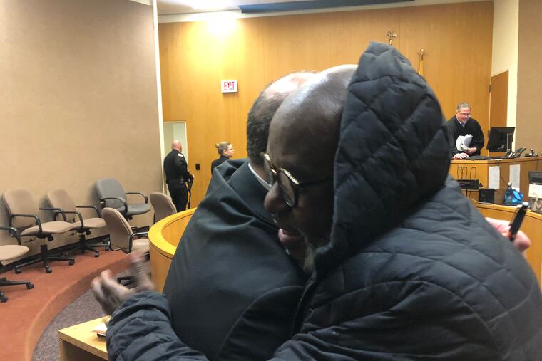 Atlantic City boys basketball coach Gene Allen hugs his attorney William Donio after a judge ordered Allen reinstated as coach for the entire 2018-19 season.