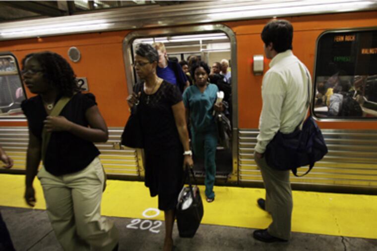 Morning commuters at the Spring Garden SEPTA stop of the Broad St Orange line where the hammer attack occurred. (Laurence Kesterson / Inquirer)