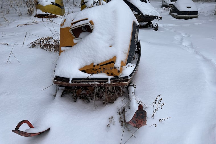 Fresh snow covers old snowmobiles on display in Lowville, N.Y.,on Saturday, Dec. 27, 2025.