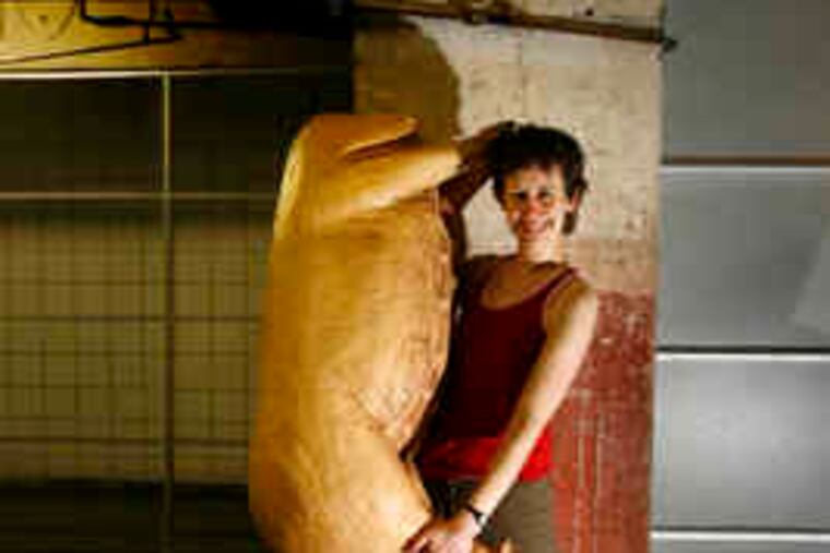 Sarah Sanford of Pig Iron Theatre Company, with a fake pig carcass, a prop for "Appetite." The show deals with the vagaries of human appetite, because for her the act of eating can be so revealing, so moving.