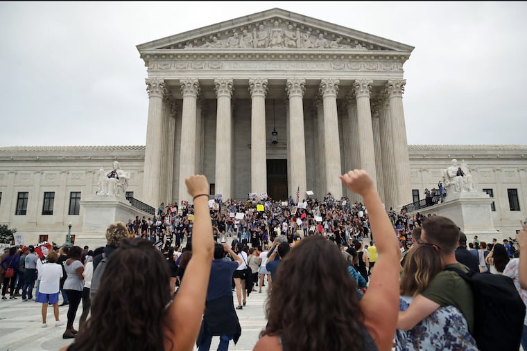 Activists protest on the steps and plaza of the Supreme Court after the confirmation vote of Supreme Court nominee Brett Kavanaugh, on Saturday.