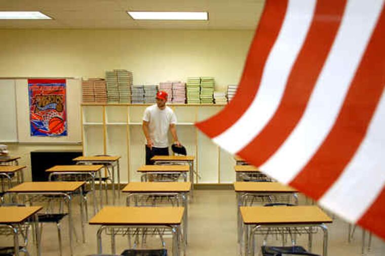 Teacher David Tyrell sets up his classroom in the new elementary/middle school in Bristol Borough. About 900 students will attend the school.