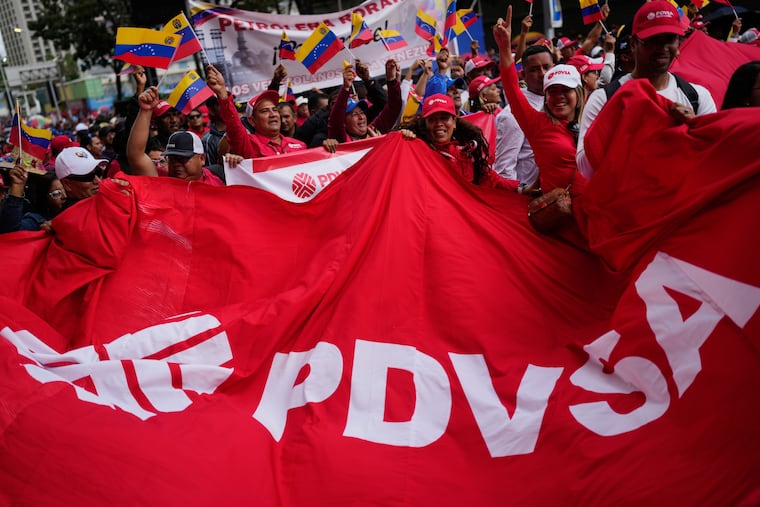 Workers of Venezuela's state-owned PDVSA oil company rally in Caracas to back an oil reform bill proposed by acting President Delcy Rodriguez.
