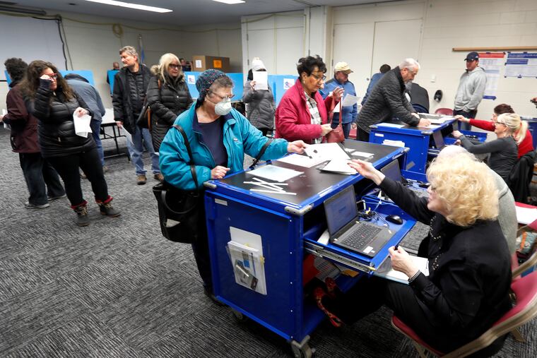 Chicago residents line up for early voting at the Roden Library Monday, March 16, 2020, in Chicago.