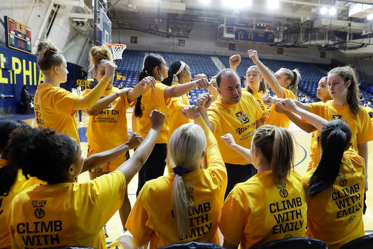 La Salle women's basketball Head Coach Mountain MacGillivray meets with his players as they wear their "Climb with Emily" t-shirt before La Salle played Richmond on Sunday, January 23, 2022. The Explorers have partnered with the B+ foundation to raise funds and awareness for pediatric cancer. The game was dedicated to La Salle Head Coach Mountain MacGillivray's daughter, Emily, who is currently in the fight against Acute Lymphoblastic Leukemia.
