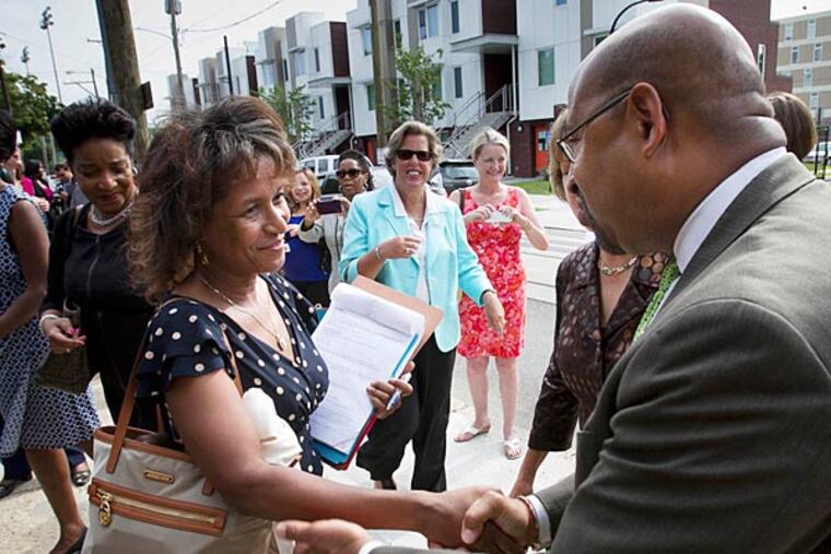 Mayor Nutter greets HUD official Jemine Bryon at yesterday’s announcement of a $30 million grant to revitalize Norris Apartments and the surrounding area near Temple. (Alejandro A. Alvarez/Staff)