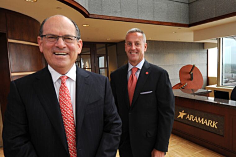 Aramark chairman Joseph Neubauer (left) with the firm's new chief executive, Eric J. Foss. APRIL SAUL / Staff Photographer