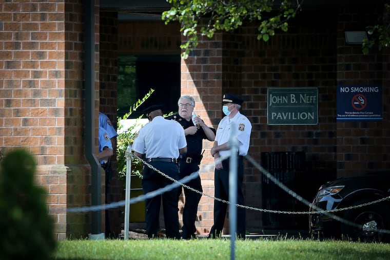 A Jefferson Hospital public safety officer (center) talks with Philadelphia police as they gather outside Jefferson Health Torresdale Hospital in Philadelphia, Pa. on June 24, 2020. Immigration activists say Jefferson Health is trying to “medically repatriate” an undocumented Guatemalan man with a serious brain injury in an effort to rid itself of his care, and they vowed to block any vehicle attempting to transport him to the airport.