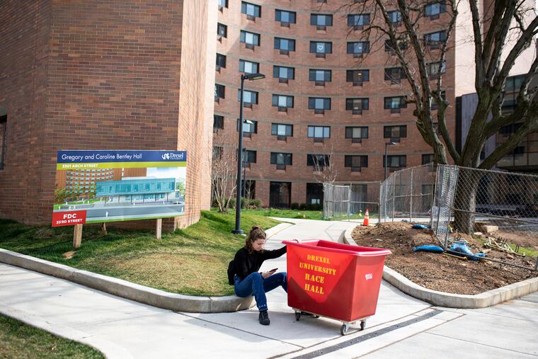 Zoe Culeer, 19, of Cherry Hill, N.J., a freshman studying entertainment and arts management, waits for her boyfriend as she brings some of his belongings to him at Drexel University on Friday, March 20, 2020. “It’s all surreal, It’s hard to put this into words,” Culeer said. “Even though we saw it coming, no one could really prepare for this.”