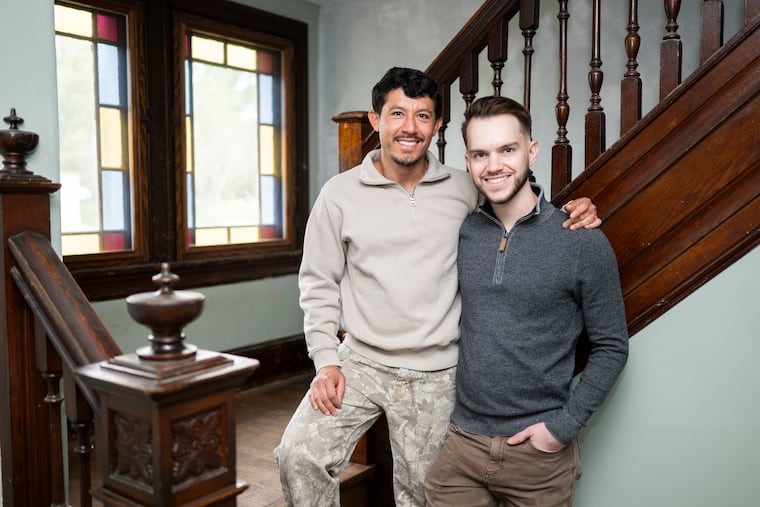 Martin Alfaro (left) and Kyle Taveira (right) were drawn to the house's character and features, such as the original wood staircase and stained-glass windows in the living room.