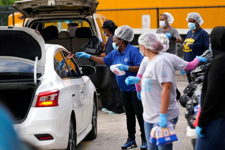 Houston Independent School District Nutrition Services workers distributing food last April.