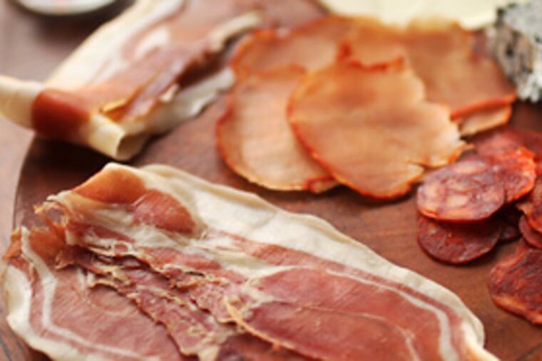 Ibérico ham (front), serrano ham (left), sliced chorizo (right), lomo embuchado (middle). At Cafe Apamate.