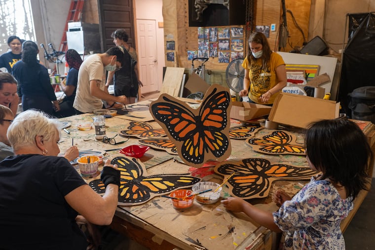Volunteers paint cardboard butterflies at an art-building event organized by the Pennsylvania Immigration Coalition on Saturday at Spiral Q, an arts organization in West Philadelphia.