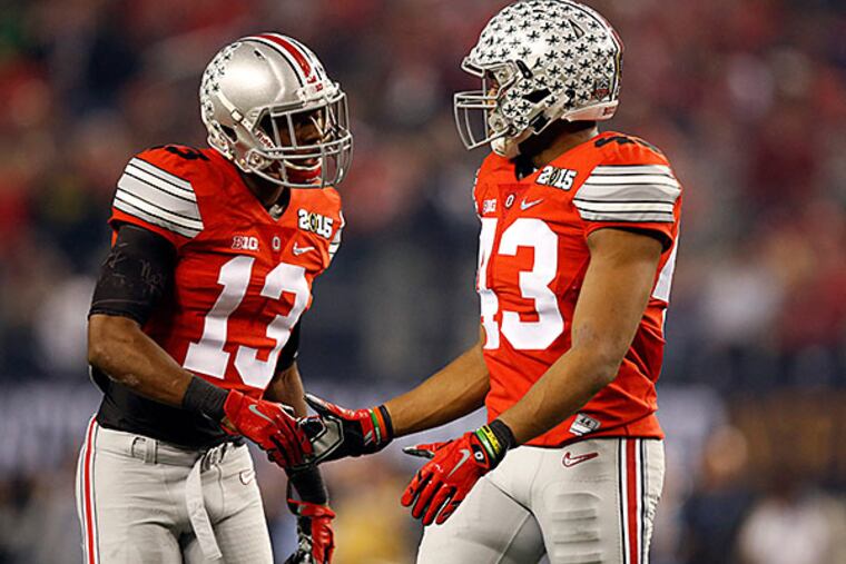 Ohio State cornerback Eli Apple (13) and linebacker Darron Lee (43) celebrate. (Tim Heitman/USA Today)
