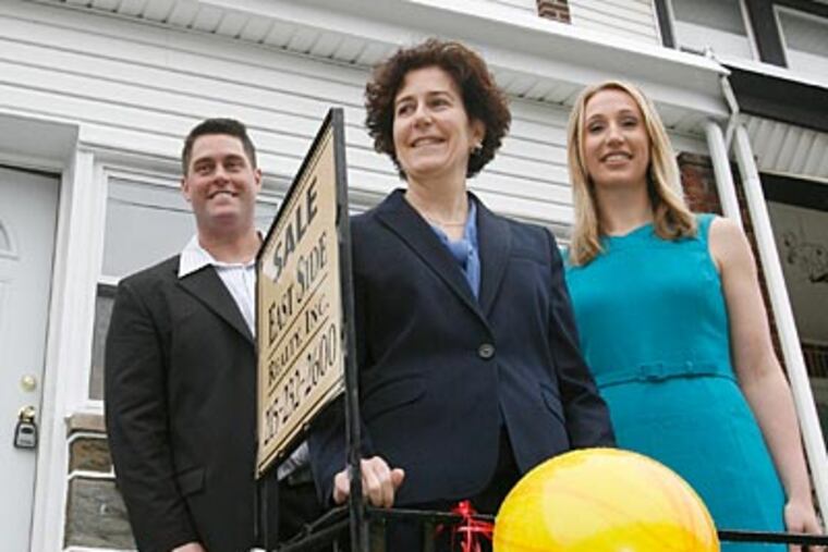 Quietly for the last 14 months, the Redevelopment Authority (led by Executive Director Terry Gillen, center) has been using $20 million in federal stimulus money to acquire houses that have been foreclosed upon. ( Charles Fox / Staff Photographer )