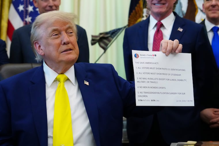 President Donald Trump holds up an image taken from his Truth Social account at an event about coal, Thursday, June 4, 2026, in the Oval Office of the White House in Washington.