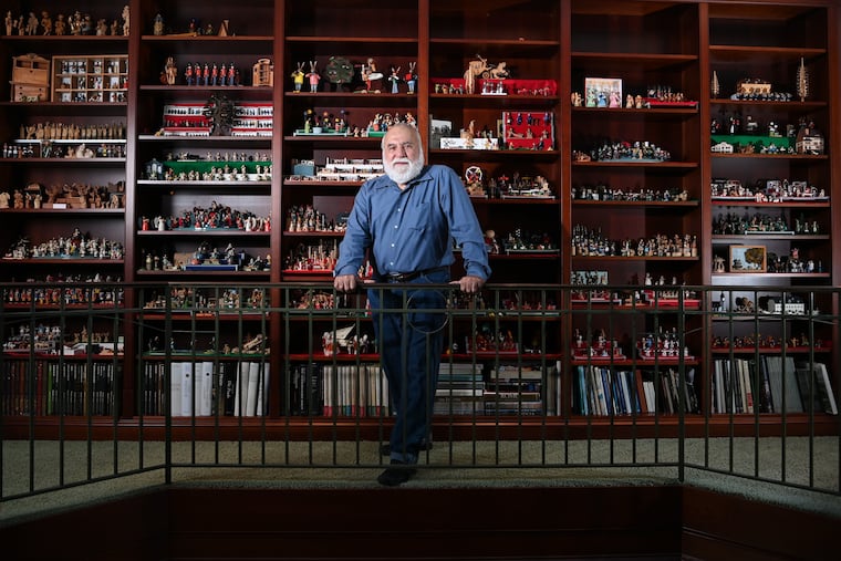 Jorge Flores in front of a portion of his miniature collection at his home in Potomac, Md.