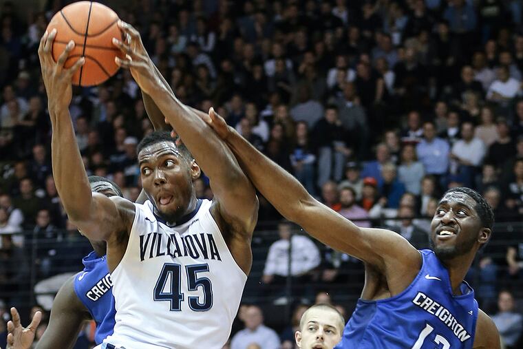 Villanova forward Darryl Reynolds grabs a rebound from Creighton
forward Cole Huff.