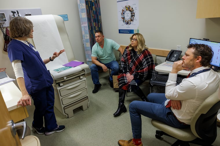 Martha Thompson, a registered nurse, talks about the medication with Irene Blair and Blair's husband, Charles Blair. Irene has pancreatic cancer and is participating in a trial.