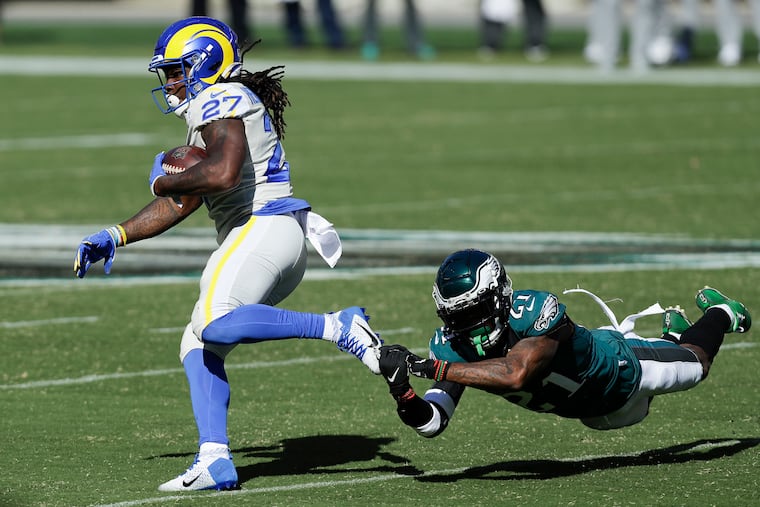 Eagles strong safety Jalen Mills dives after Los Angeles Rams running back Darrell Henderson during the fourth quarter of Sunday's 37-19 loss.