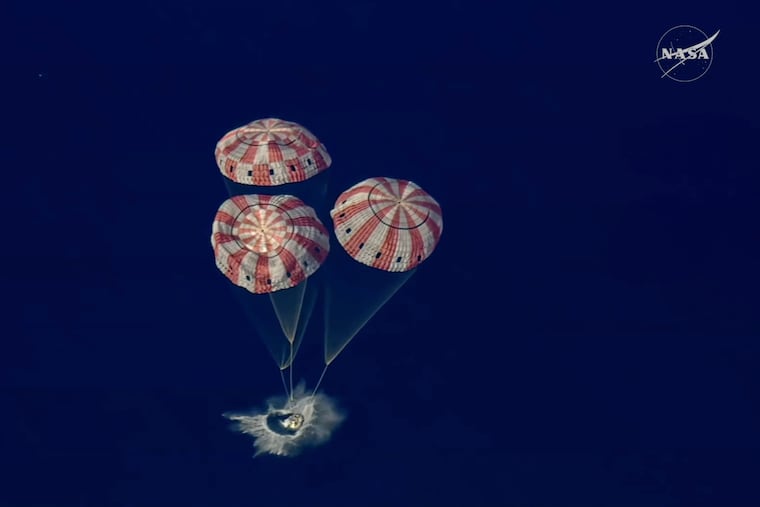 The Artemis II Orion capsule splashes down in the Pacific Ocean.