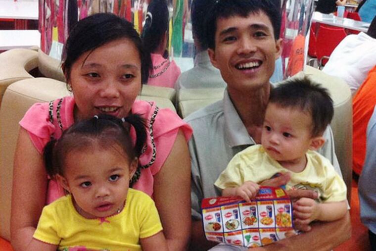 Vu The Phong (right) shown with his family, will visit Philly. (FAMILY PHOTO)