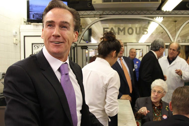 Lt. Gov. Mike Stack, left, visits Famous 4th Street Deli on Election Day in Philadelphia on November 4, 2014.