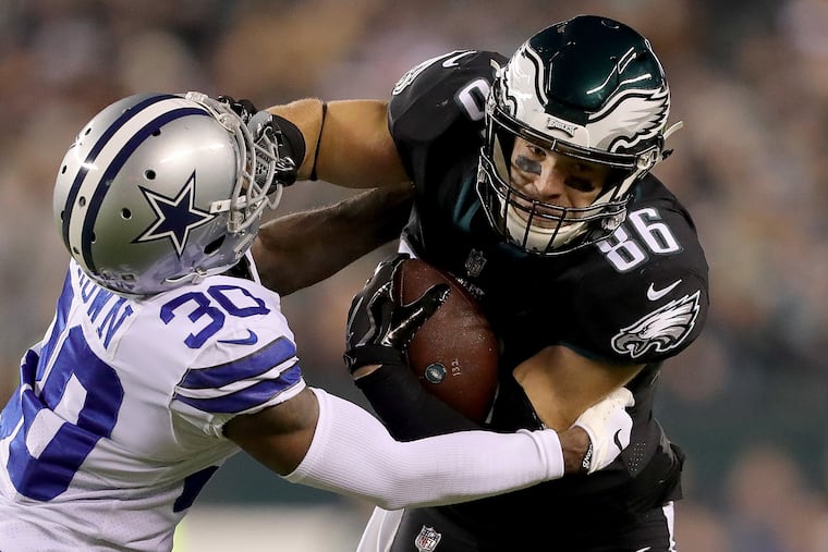 Eagles Zach Ertz, right, gives a stiff-arm to Cowboys defender Anthony Brown as the Eagles play the Dallas Cowboys at Lincoln Financial Field in Philadelphia, PA on November 11, 2018. DAVID MAIALETTI / Staff Photographer