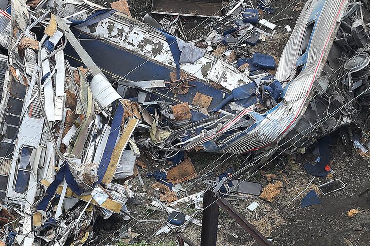 The remains of one of the rail cars from Amtrak Train 188 rest at the scene in Port Richmond on May 13, 2015. (DAVID MAIALETTI/Staff Photographer)