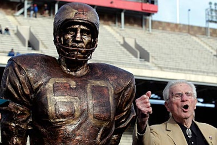 Chuck Bednarik stands next to his statue that was unveiled Saturday at Franklin Field. (Akira Suwa/Staff Photographer)