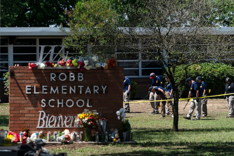 Investigators search for evidence outside Robb Elementary School in Uvalde, Texas, on May 25, after an 18-year-old gunman killed 19 students and two teachers.